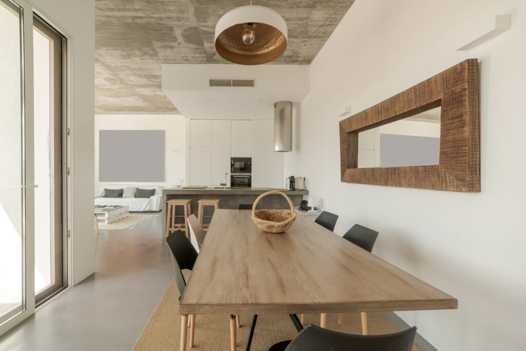 Modern kitchen interior in West Palm Beach with sleek cabinets, spacious island and table, showcased with real estate photography from Next Chapter Media.