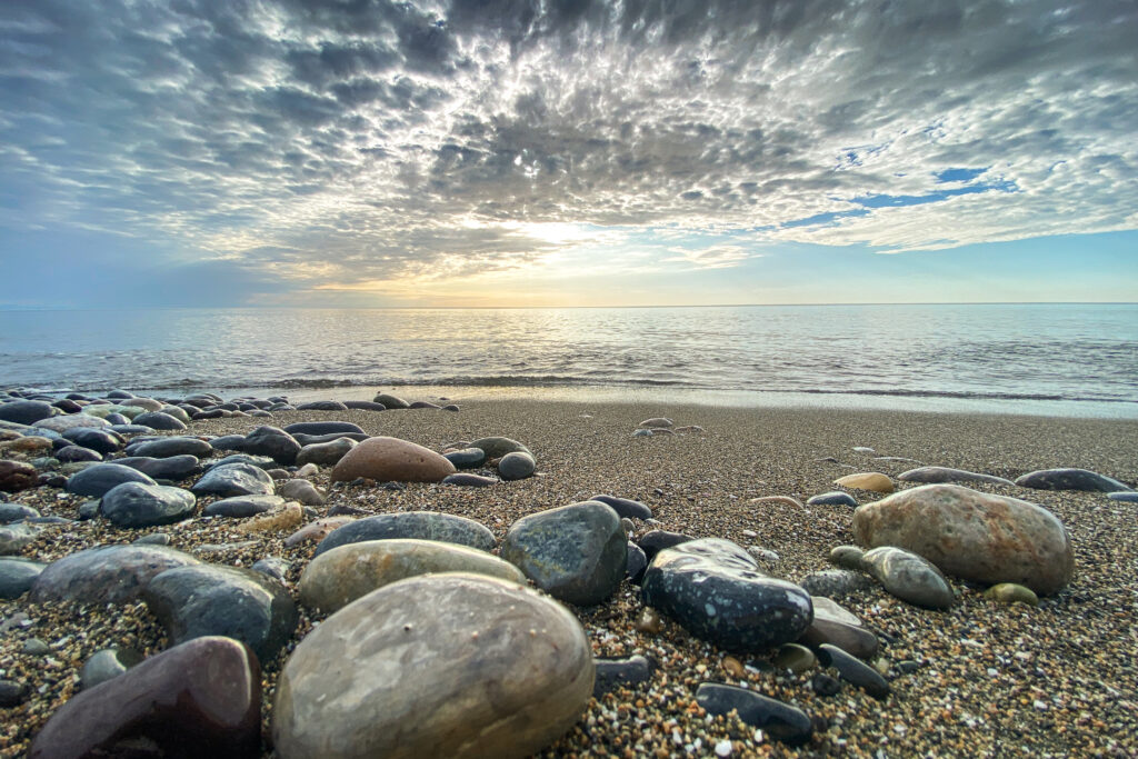 Scenic view of South Florida beach with prominent rocks along the shoreline.