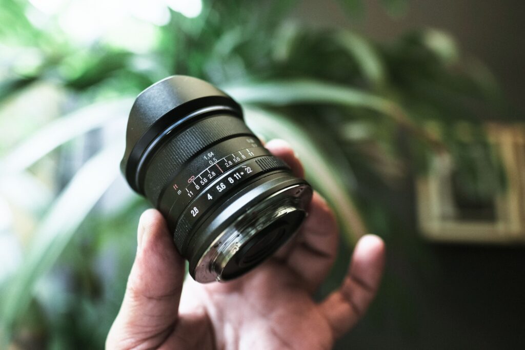 A hand holding a wide-angle lens, ready to capture the essence of Boynton Beach