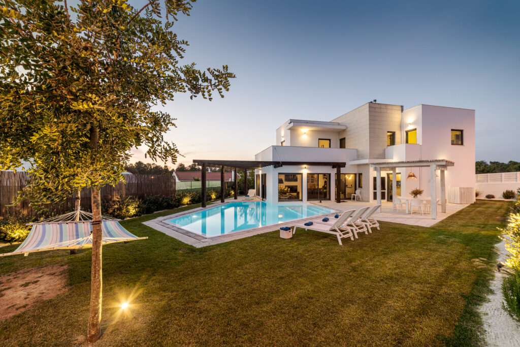 Modern home with pool at dusk in Delray Beach