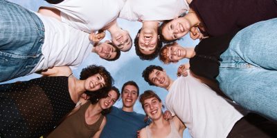 Group of people posing outdoors, emphasizing the importance of composition in captivating portrait photography.