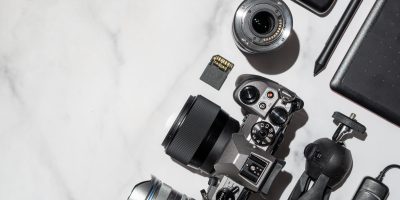 Essential photography gear neatly arranged on a white table, ready to embark on your photographic journey.