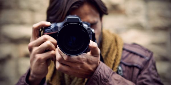 Man capturing a captivating moment with a camera, exploring the world of photography and sports photography.