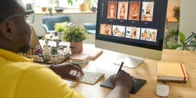 Man editing outdoor portrait photography on a computer, showcasing post-processing techniques.