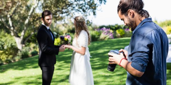 Radiant newlyweds share a joyful glance at the camera, bathed in the warm glow of their wedding day.