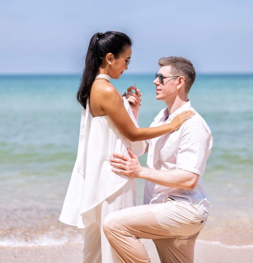 Love couple on holiday happy playing running along the beach and wedding proposed on love emotion