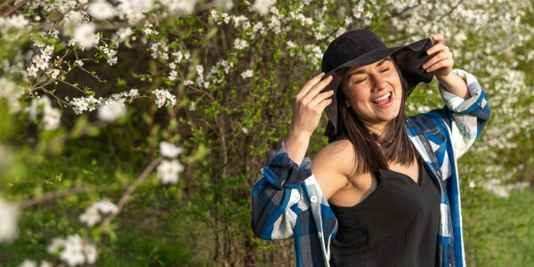 Smiling woman receiving outdoor portrait in urban setting,